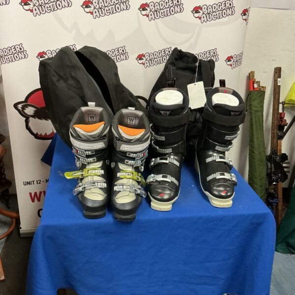 Two pairs of used ski boots for winter sports.