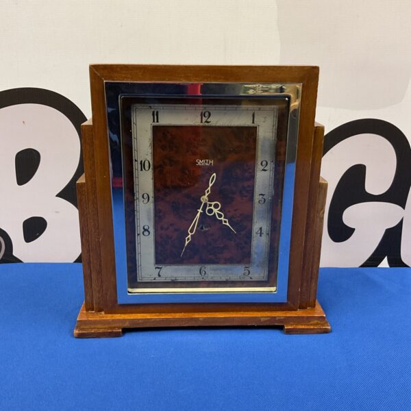 Vintage Smith Art Deco electric clock on a dark surface.