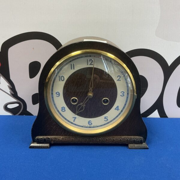 Vintage Smiths Enfield clock with white dial and black numerals.