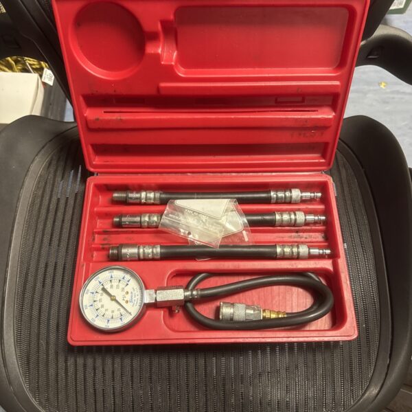 Snap On compression tester kit with gauge and adapters.