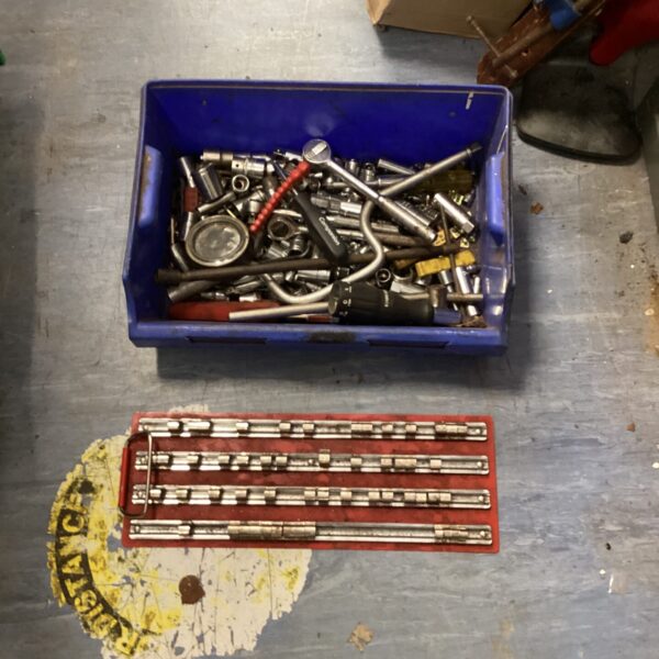 Assorted socket set and tools with hanging rack.