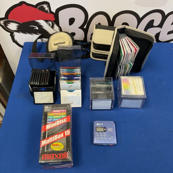 Sony MZ-R55 Mini Disc player with a collection of discs.