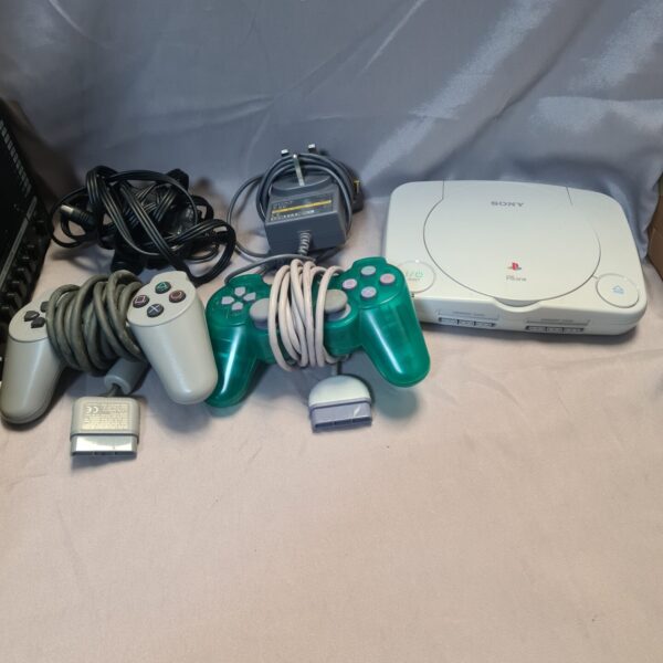 Sony Playstation 1 Slim console with controllers and leads for retro gaming.