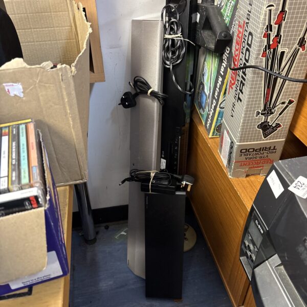 Lot of three soundbars with cables for home audio setup.