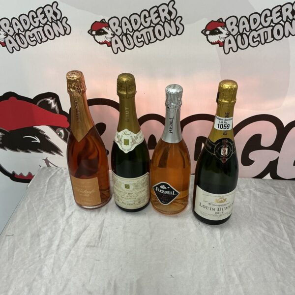 Four bottles of sparkling wine and champagne in a collection.