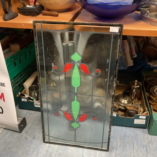 Vintage stained glass window pane measuring 76.5cm x 43cm with decorative design.