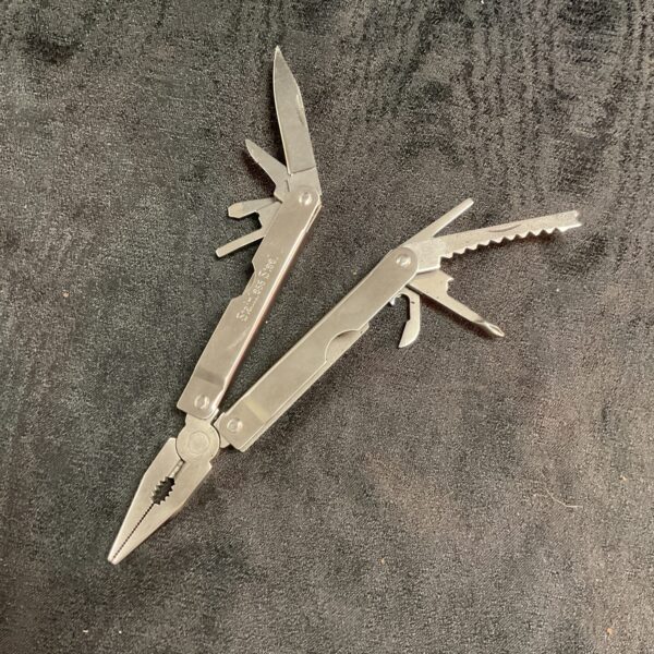 Stainless steel multi tool pliers with various implements.