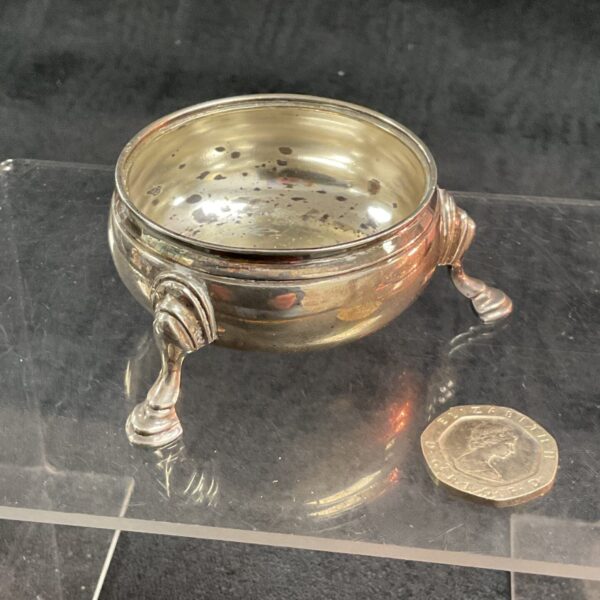 Antique sterling silver relish pot with three legs.
