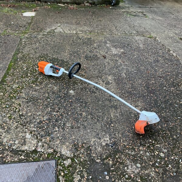 Stihl cordless strimmer for garden maintenance, showing the tool's design.