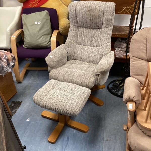 Comfortable stripey beige armchair with matching footstool.