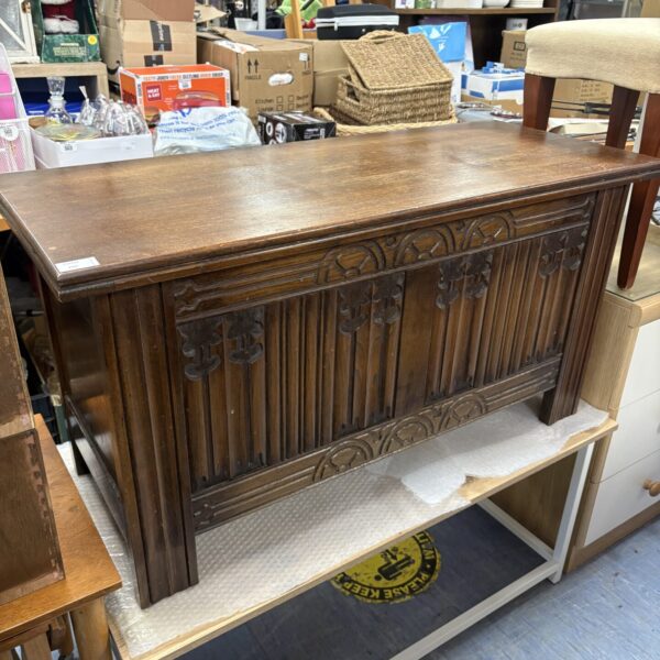 Large carved oak blanket box by Strongbow Furniture for storage.