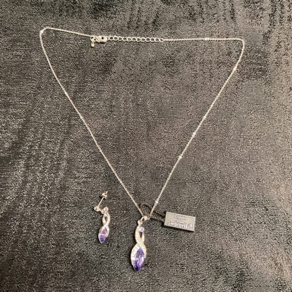 Elegant Swarovski crystal chain necklace with purple pendants.