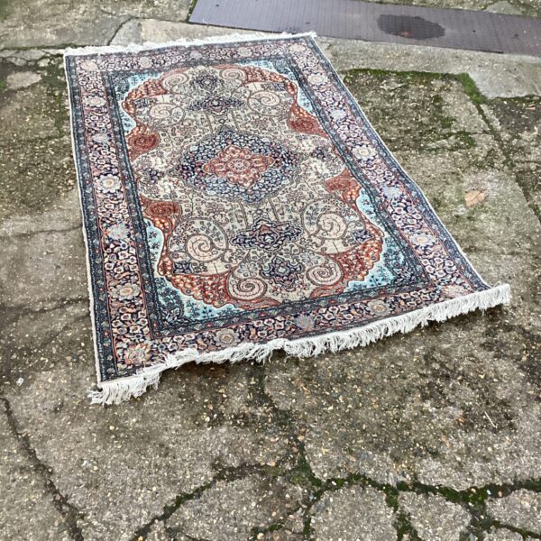 Intricate floral design on a vintage Tabriz rug.