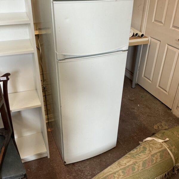 White tall fridge freezer appliance in used condition.