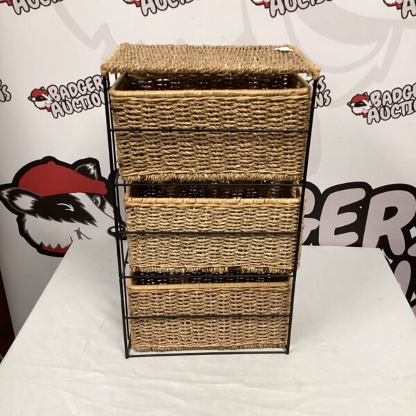 Tall wicker storage unit for bathroom or bedroom organisation.