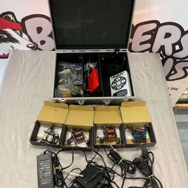 Worldwide tattoo supply kit with machines, inks, and accessories.