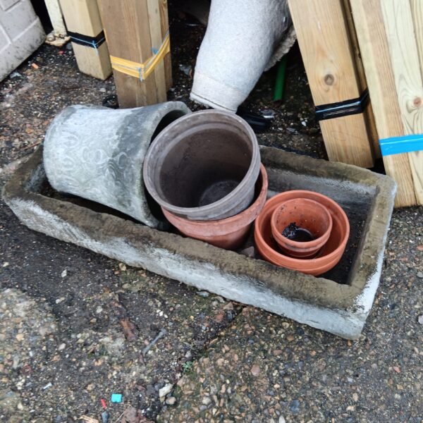 Vintage terracotta and stoneware plant pots with a trough planter.