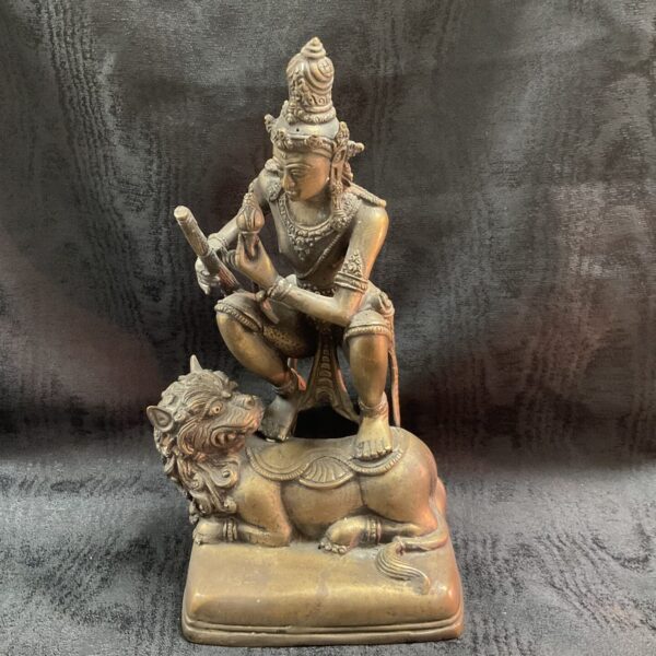 Antique Tibetan Buddhist deity sculpture on tiger base.
