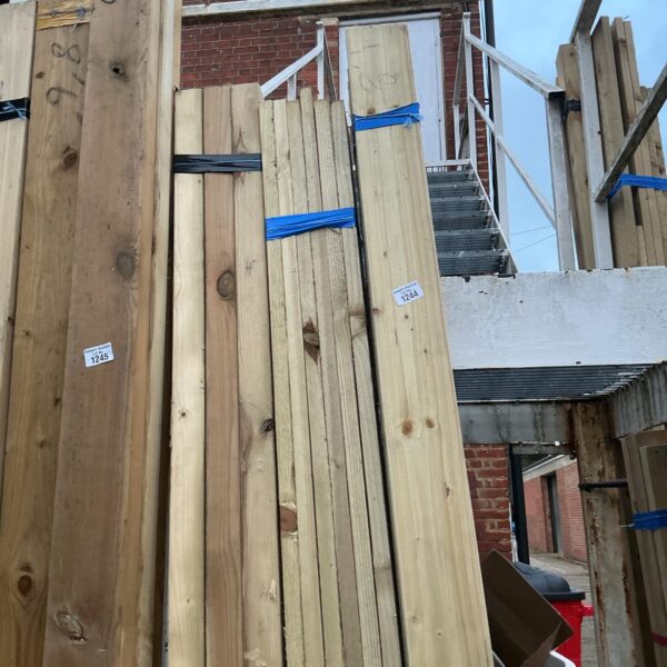 Stack of softwood timber bundles for construction projects.