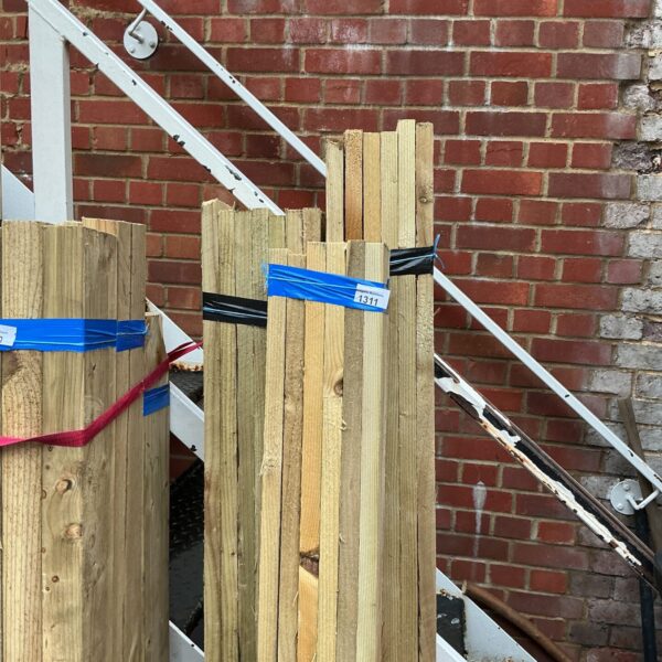 Strapped bundles of timber ready for construction or DIY projects.