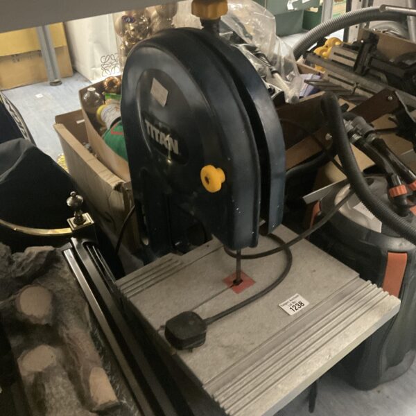 Vintage Titan bandsaw in a workshop setting.