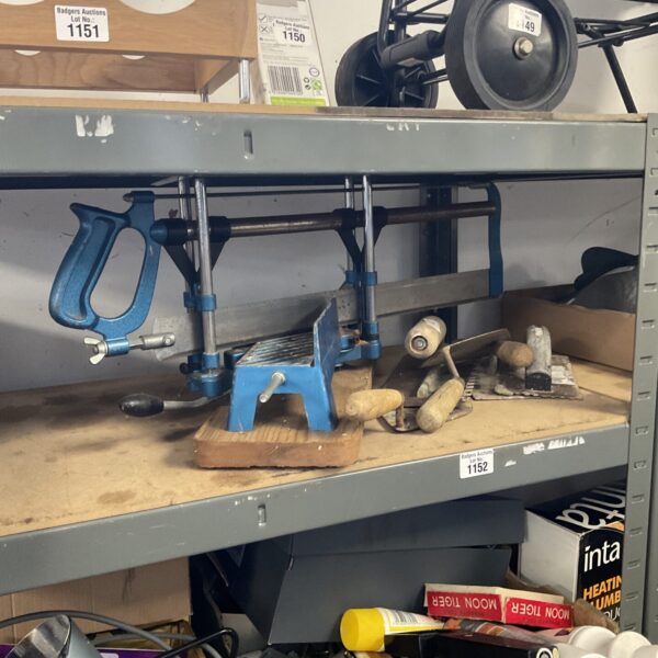 Vintage tool selection featuring a mitre saw and trowel.