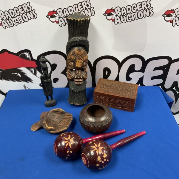 A selection of tribal carved wooden items including a totem and box.