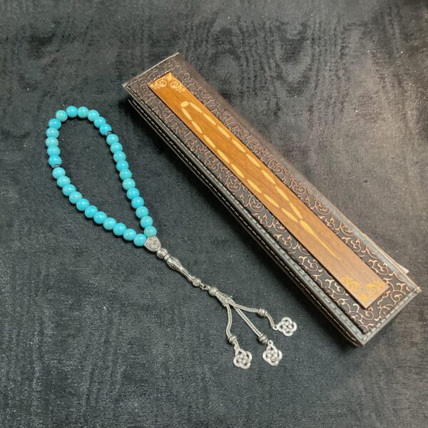 Turquoise tasbih with 33 beads for Islamic prayer.