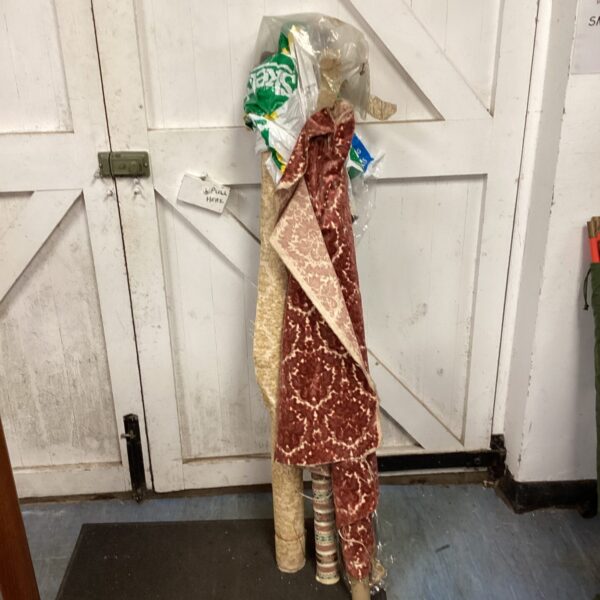 Mixed lot of upholstery fabric rolls for crafting and home decor.