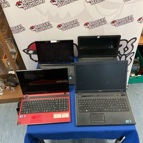 Used laptops lot including Acer, Dell, Lenovo, and Compaq.