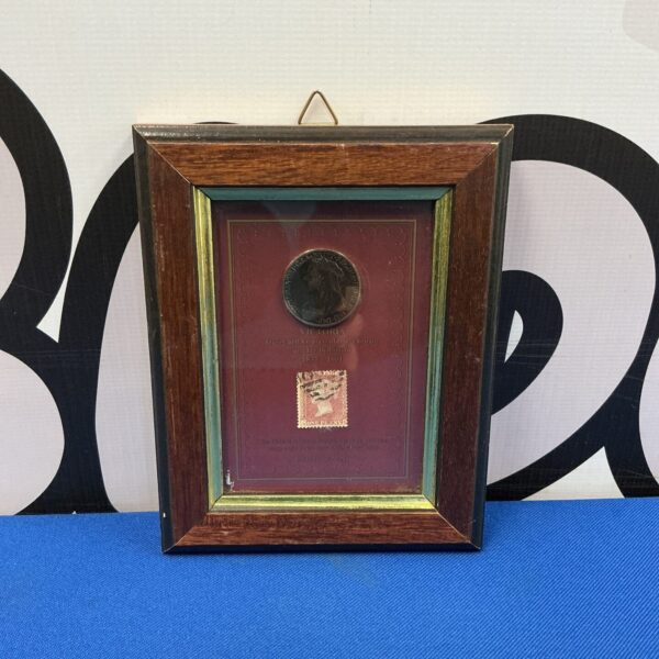 Framed Victorian Penny Red stamp and coin display for collectors.
