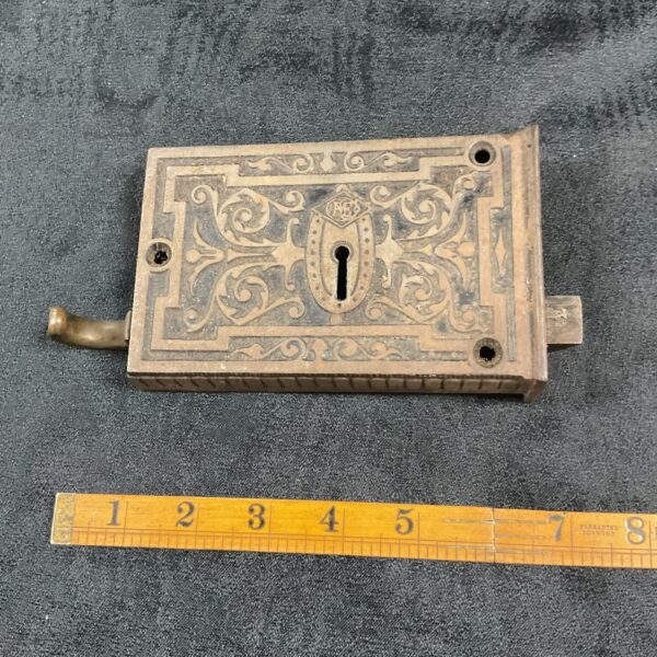 Ornate Victorian cast iron door lock with keyhole.