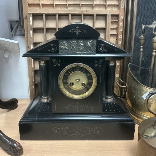 Victorian slate mantle clock with Roman numeral face.