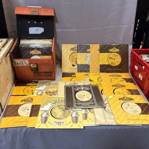 Vintage 7 inch records in a cardboard box, a collectible music lot.