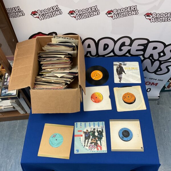 Vintage lot of 7 inch vinyl records for collectors and music lovers.