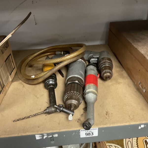 Vintage selection of pneumatic air tools for workshop use.