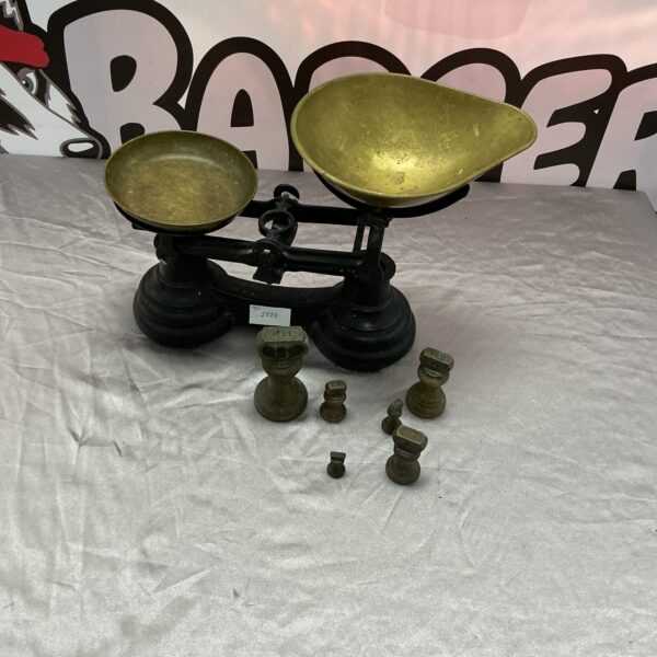 Vintage brass pan balance scales with weights.