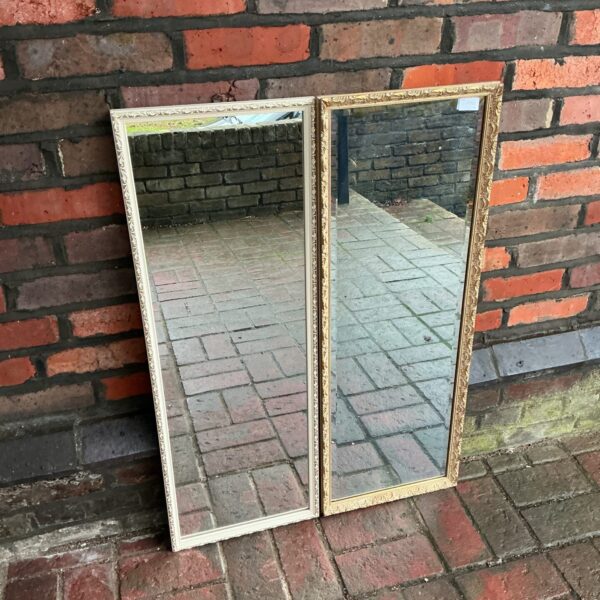 Pair of vintage bedroom mirrors with ornate frames.