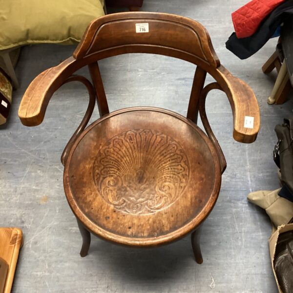 Vintage bentwood chair with sculpted seat and curved arms.