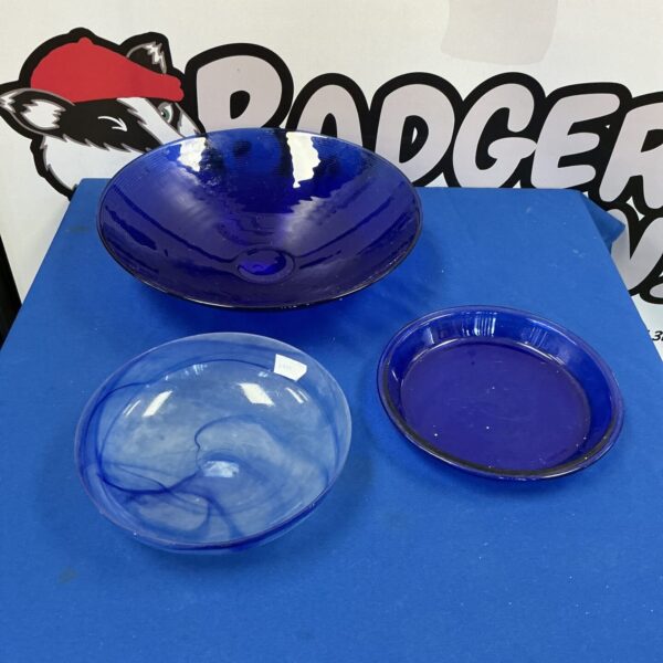 Three vintage blue glass dishes for serving or display.