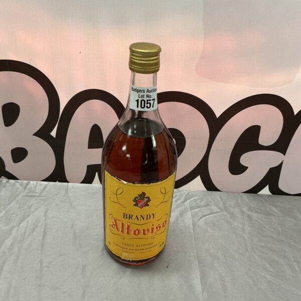 Large vintage brandy bottle with ornate label.