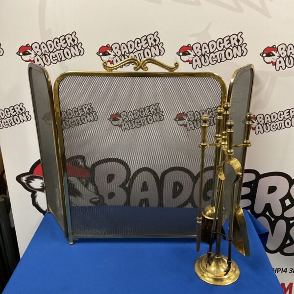 Vintage brass fireplace companion set with firescreen and tools.