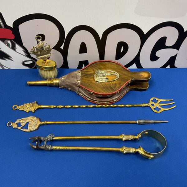 Vintage brass fireplace tools set including poker and bellows.