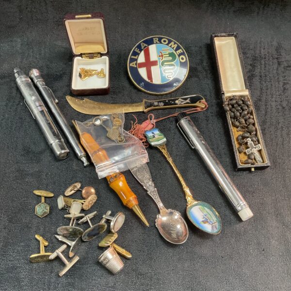 Vintage car memorabilia lot including badges, cufflinks, and spoons.