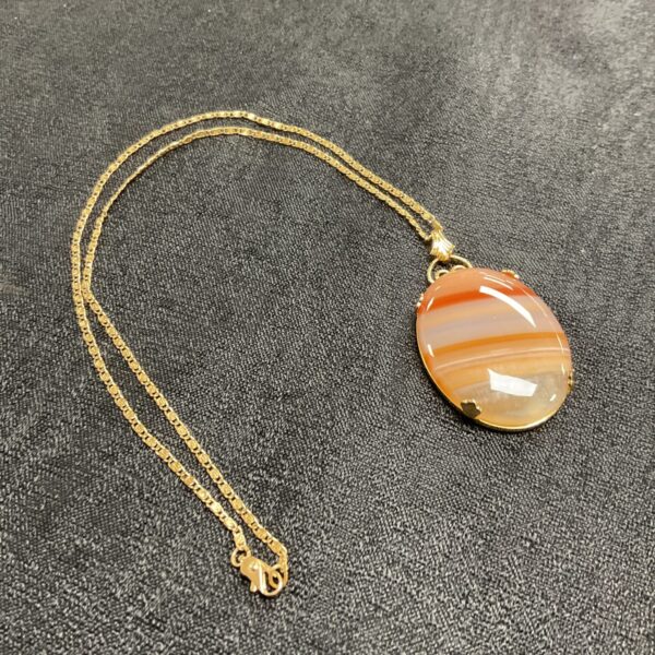Vintage carnelian pendant necklace on a gold chain.