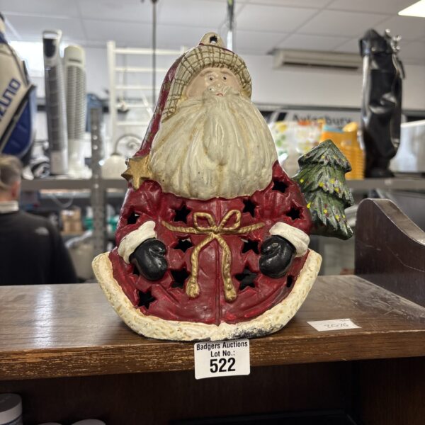 Vintage cast iron Santa door stop for holiday decor.