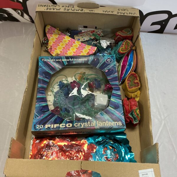 Vintage Christmas decorations in a cardboard box, retro holiday decor.