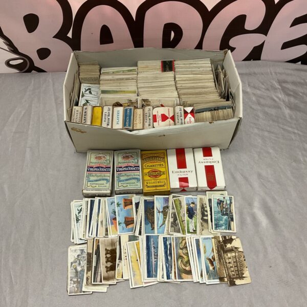 Vintage cigarette cards and boxes in a collectible lot.