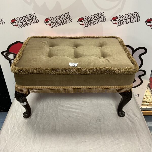 Vintage tan tasseled claw footed footstool for home decor.