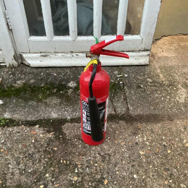 Vintage red CO2 fire extinguisher for collectors and display.